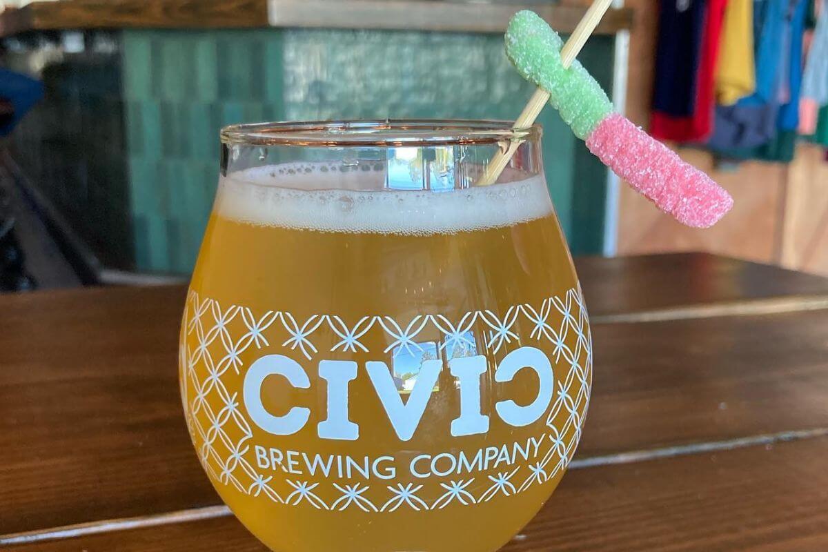 Glass with a drink and the words Civic Brewing Company on it. 
