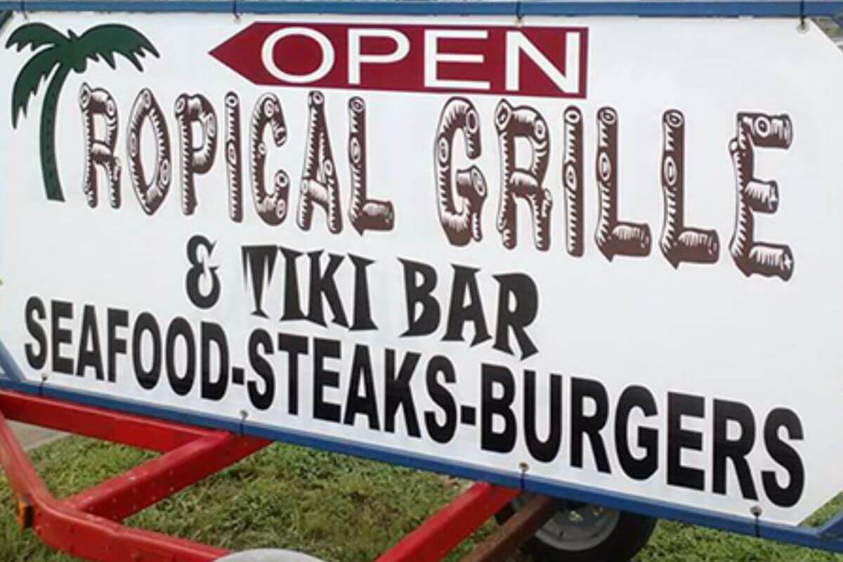 Tropical Grille and Tiki Bar sign for a restaurant near one of Florida's Unique Attractions.