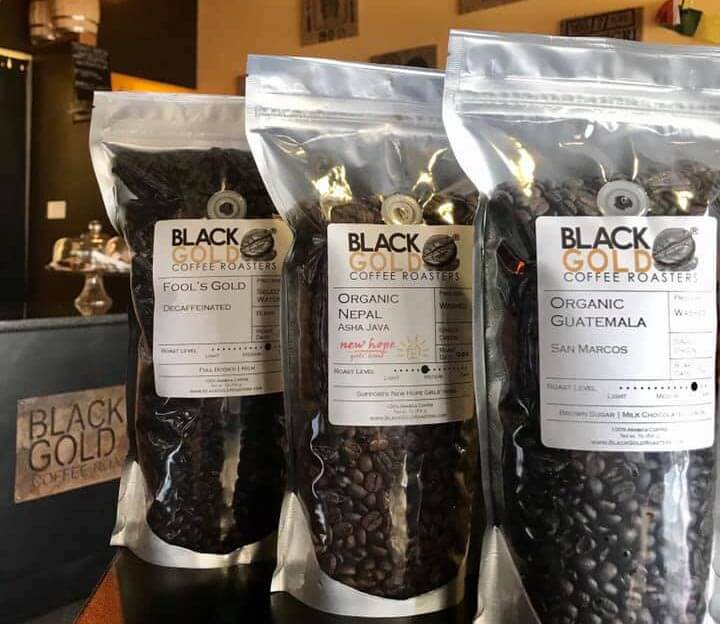 Bags of coffee beans labeled Black Gold Coffee Roasters. 