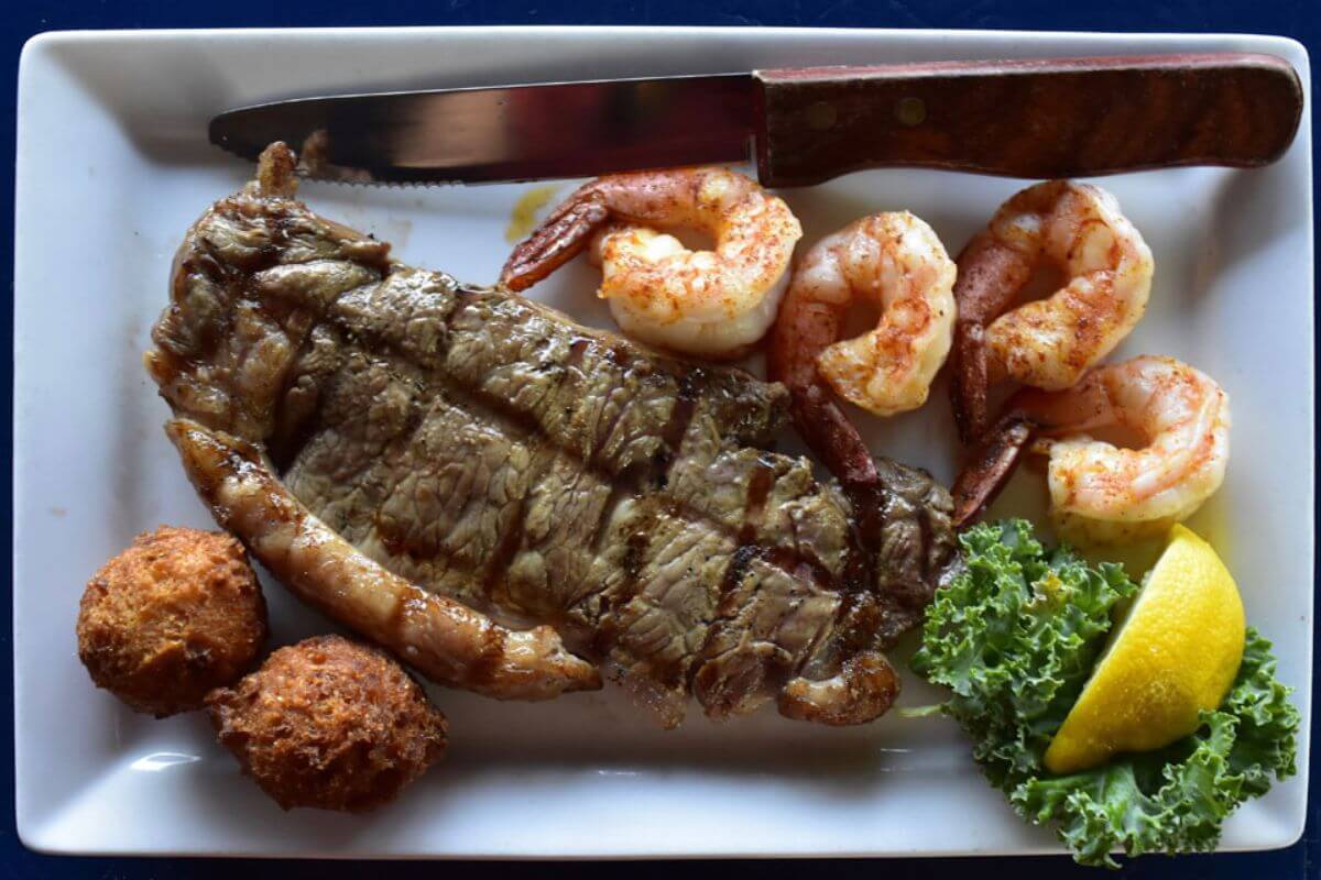 Steak and seafood on a plate. 