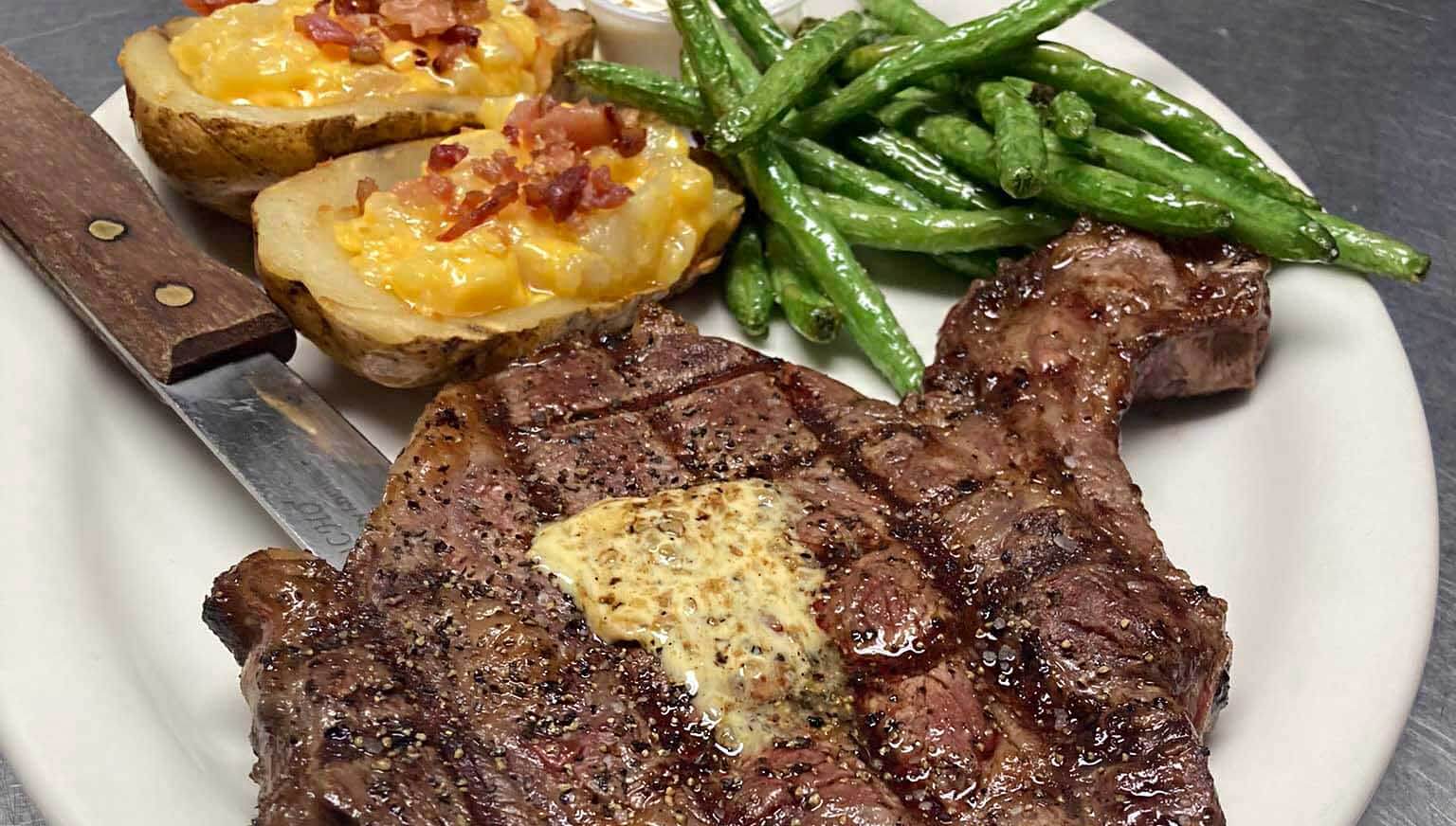 steak, twice baked potatoes, and green beans