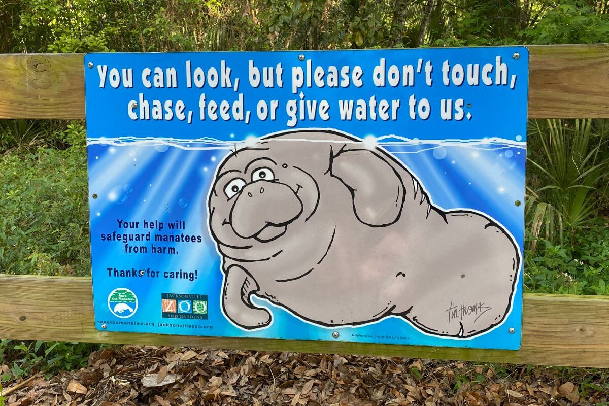 Sign that reads You can look, but please don't touch, chase, feed, or give water to us. 