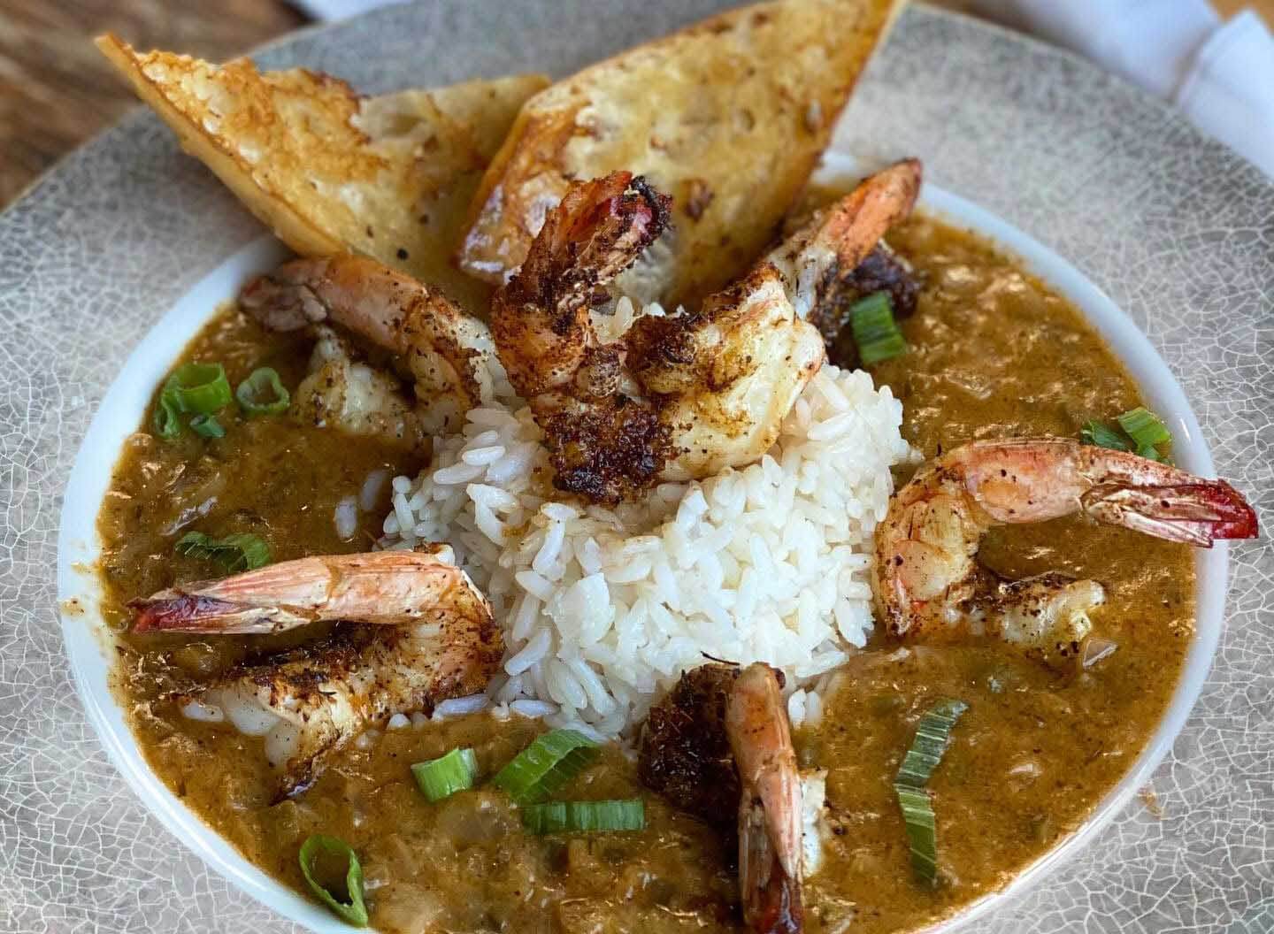 Bowl of soup with shrimp and rice. 