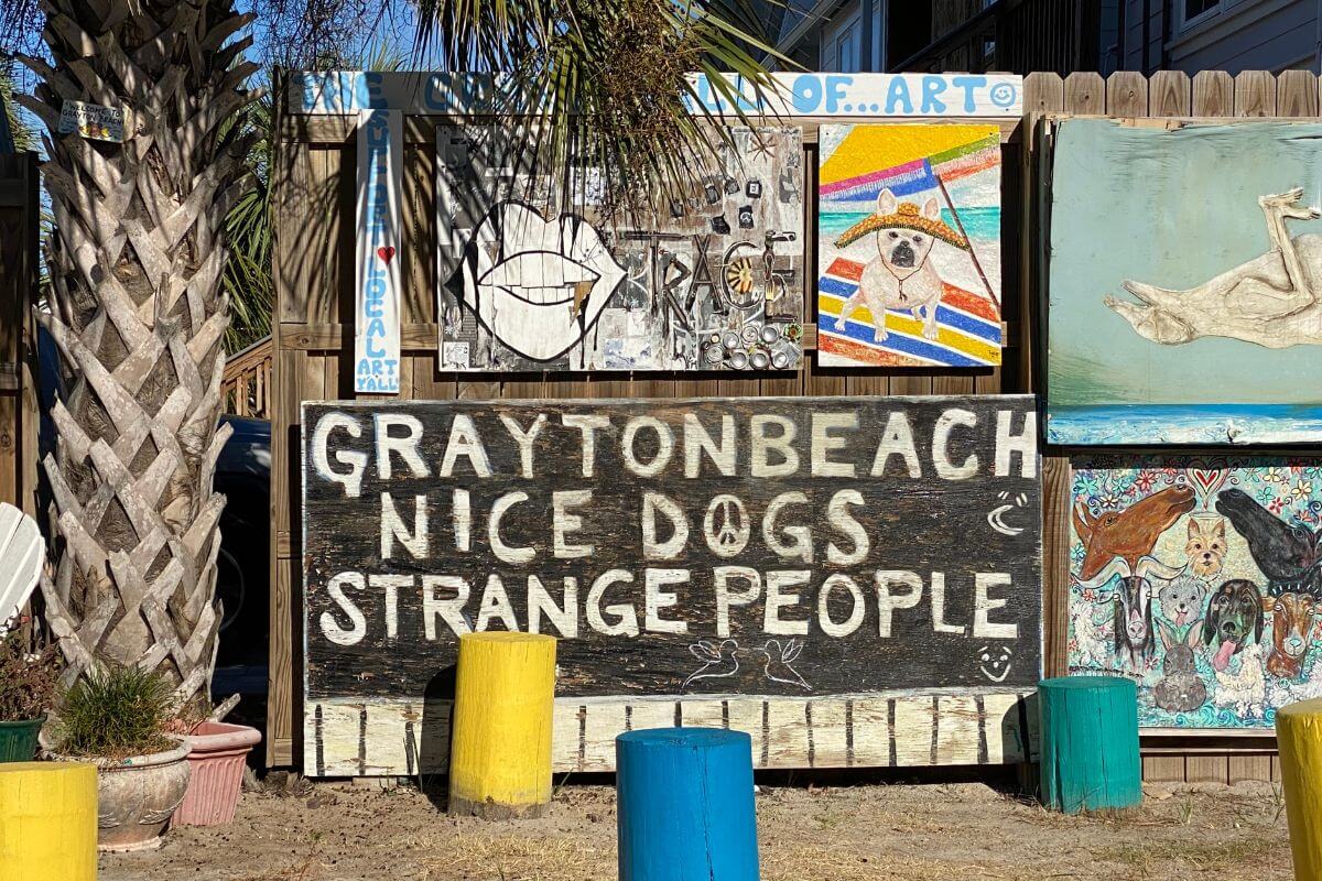 Sign that reads Grayton Beach Nice Dogs Strange People. 