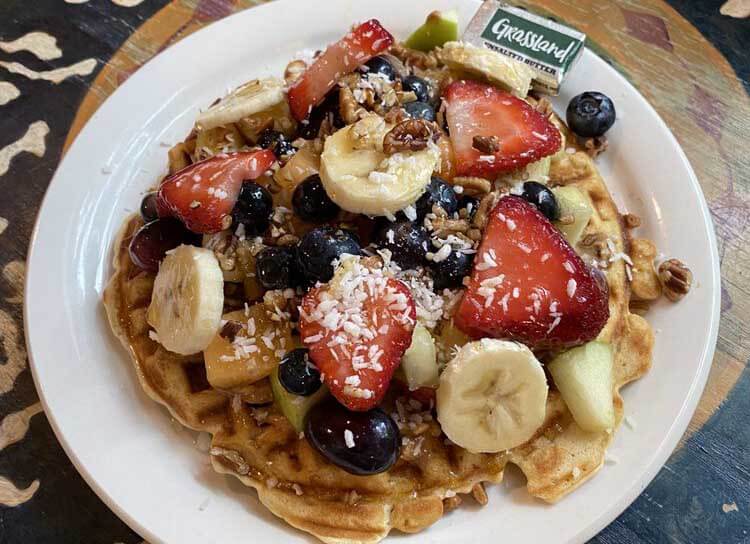 Waffles with fruit on the top. 