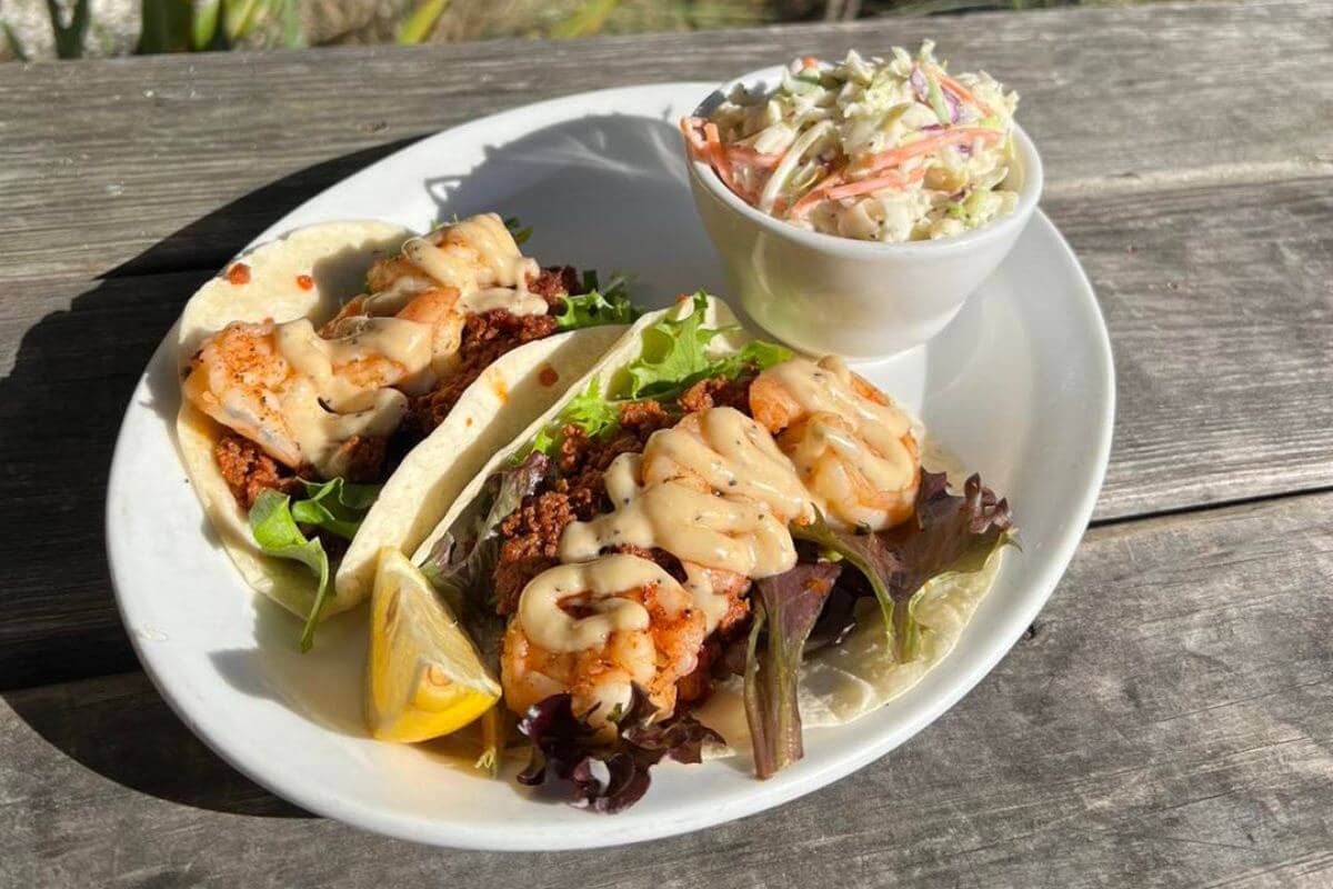 Shrimp Tacos and cole slaw on a plate. 
