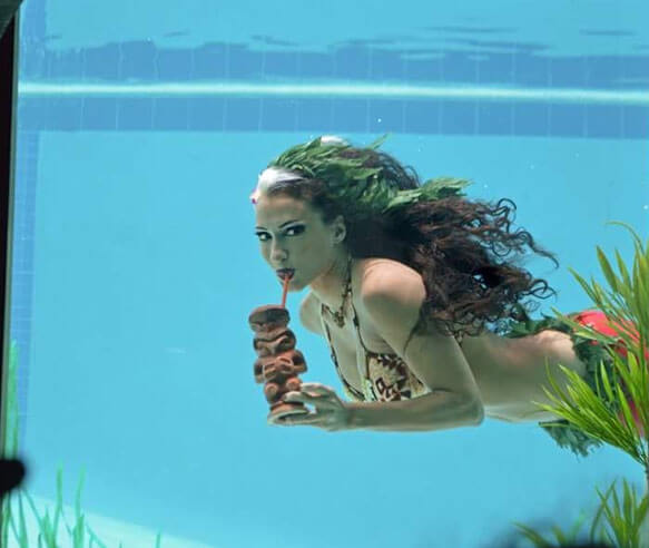 Mermaid drinking something underwater. 