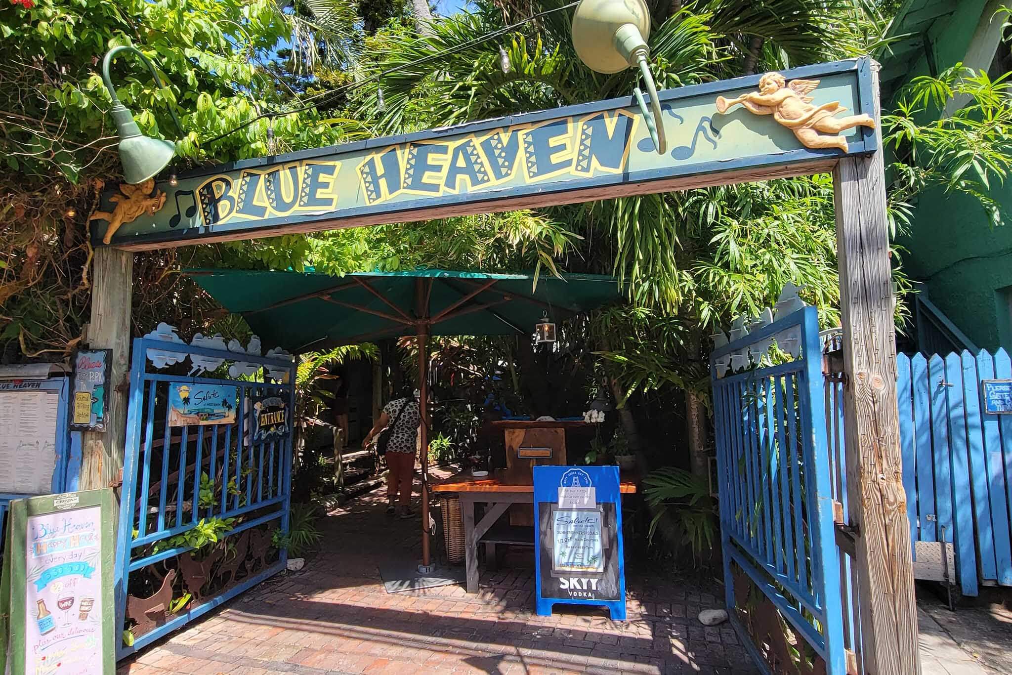 Entrance to an outdoor restaurant with a sign that reads Blue Heaven. 