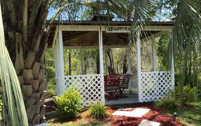 Gazebo with a sign that reads Our Happy Place. 