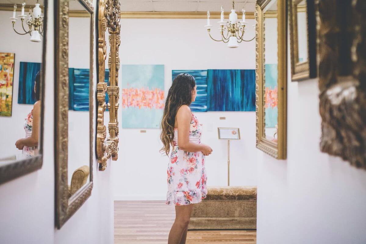 Person standing in a gallery of mirrors. 