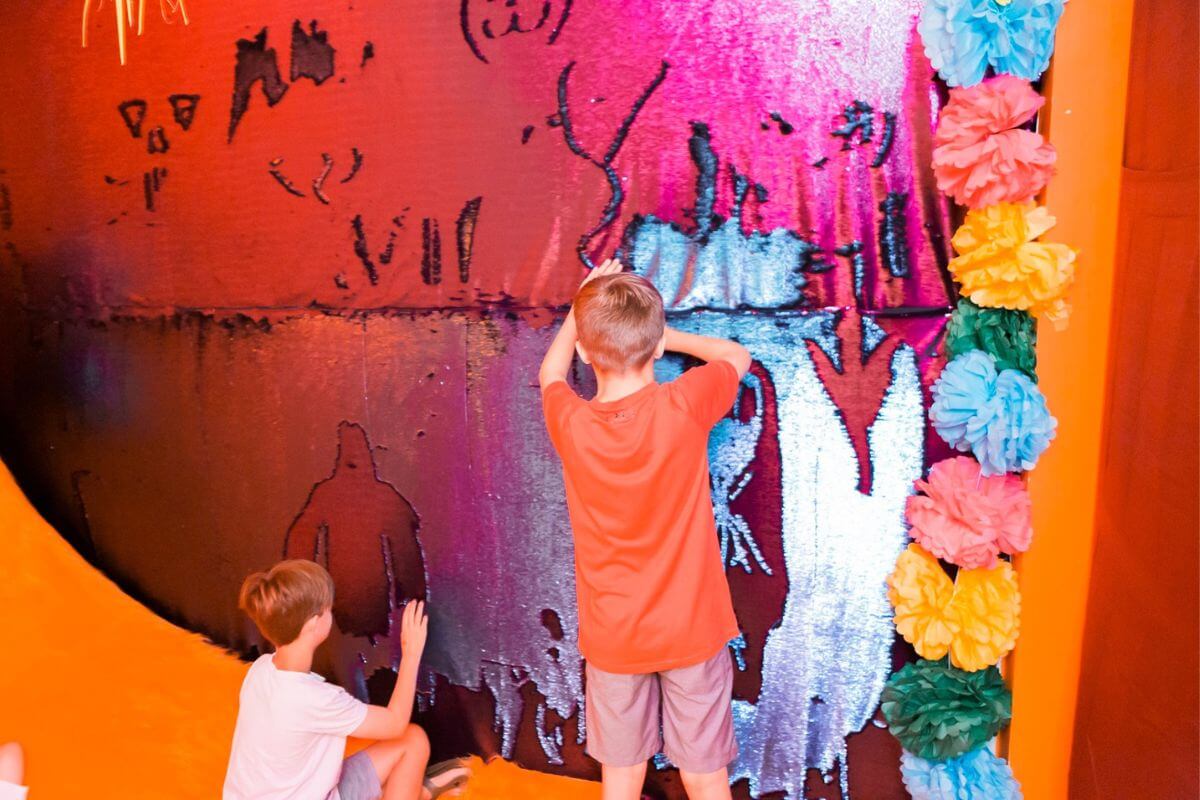 Kids touching art display. 