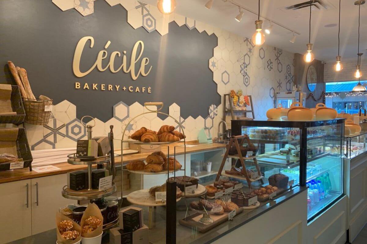 Bakery interior with wording on the wall that reads Cecile Bakery + Cafe. 