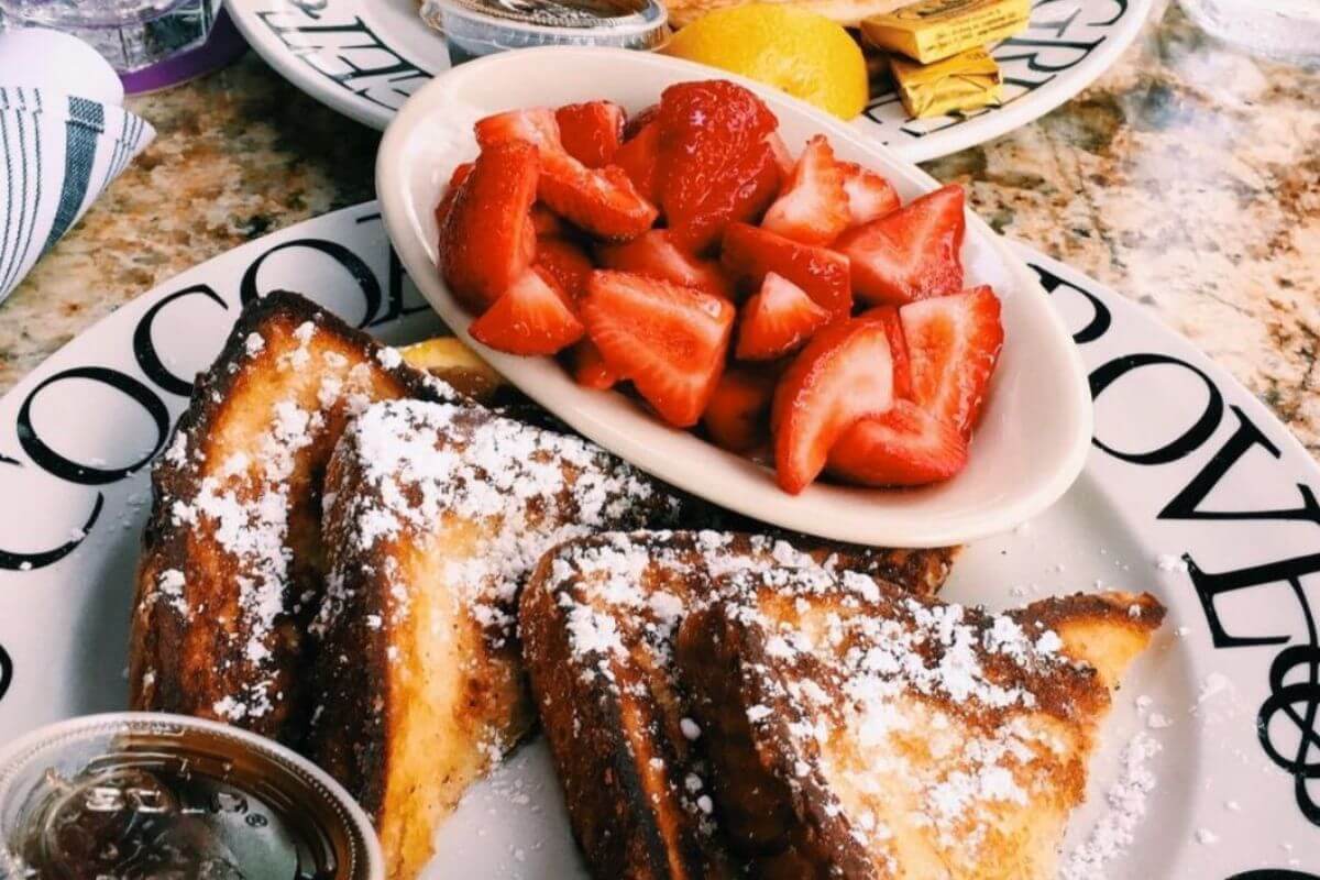 French toast and fruit on a plate. 