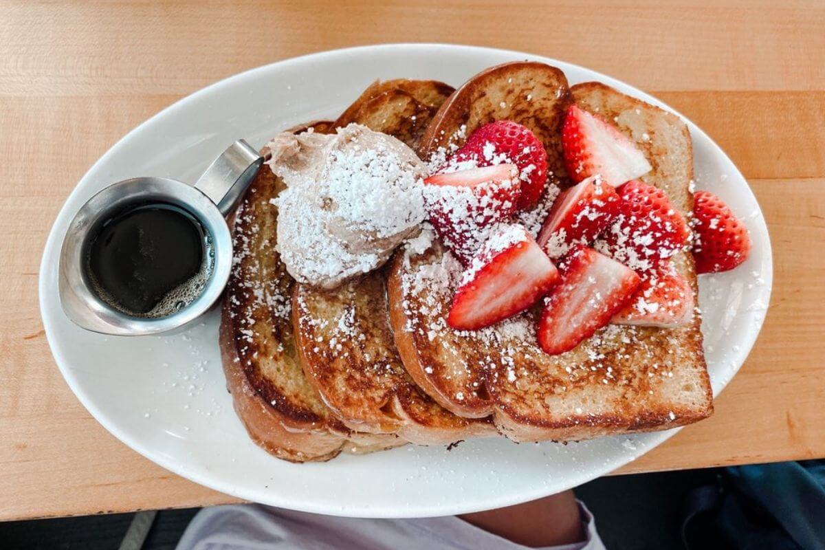 French toast topped with strawberries and powdered sugar. 
