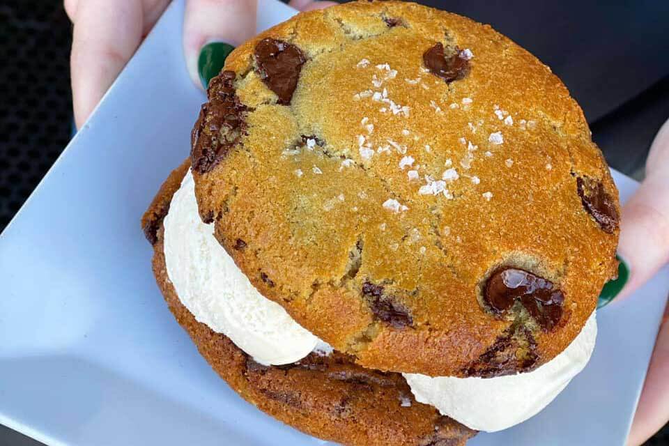 Large ice cream sandwich with two chocolate chip cookies. 