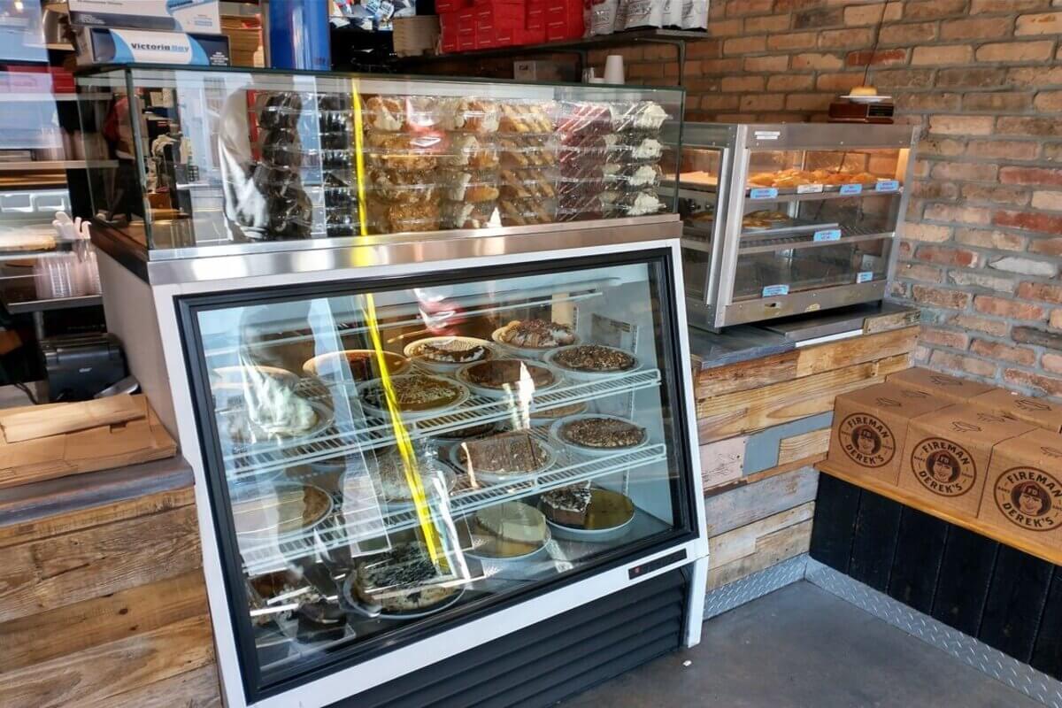 Bakery interior with a case showing pies. 