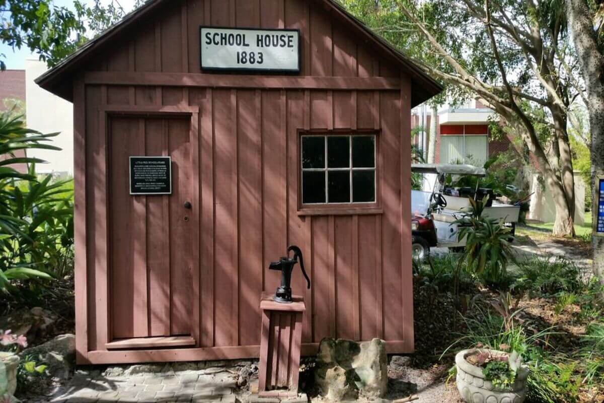School house with a sign that says School House 1883. 