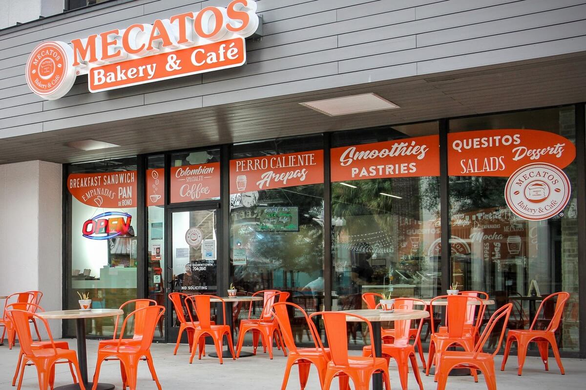Bakery exterior with a sign that says Mecatos Bakery and Cafe. 