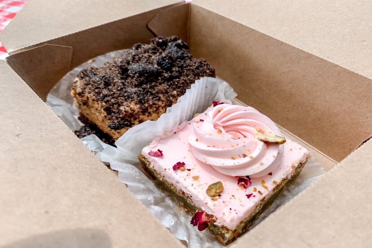 Cakes in a box. One is pink and one is brown. 