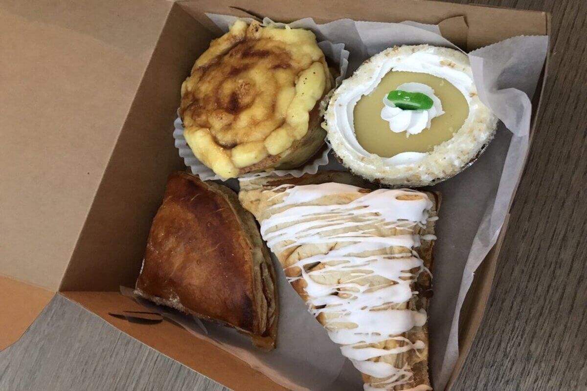 Box of baked goods including a pie and a scone. 