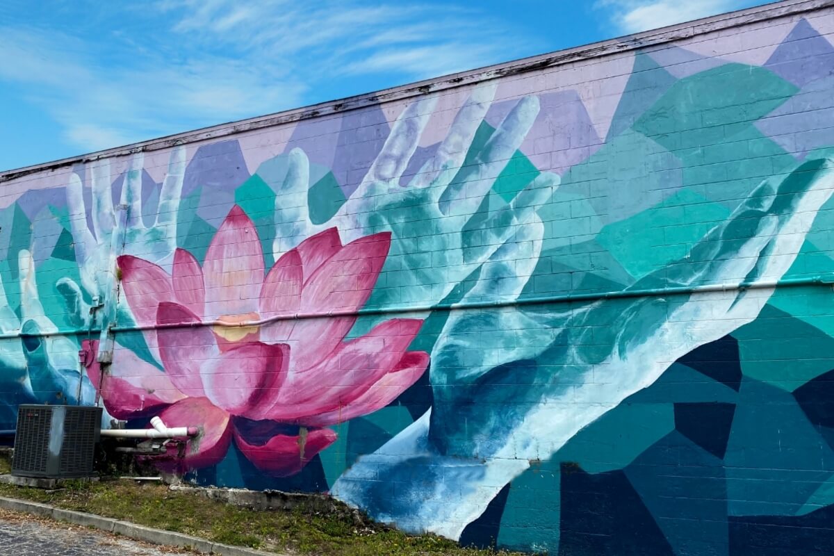 Mural of flower and hands. 