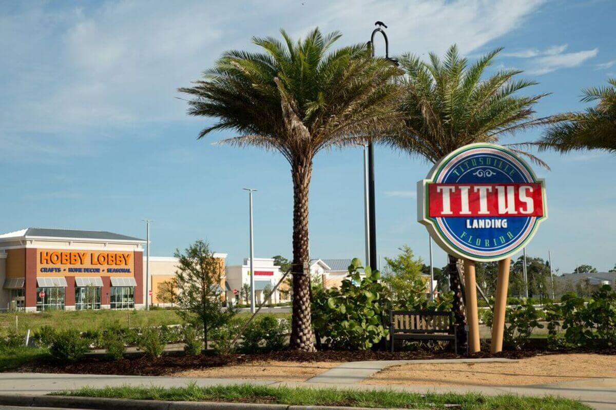 Shopping area with sign that reads Titus Landing Titusville Florida 