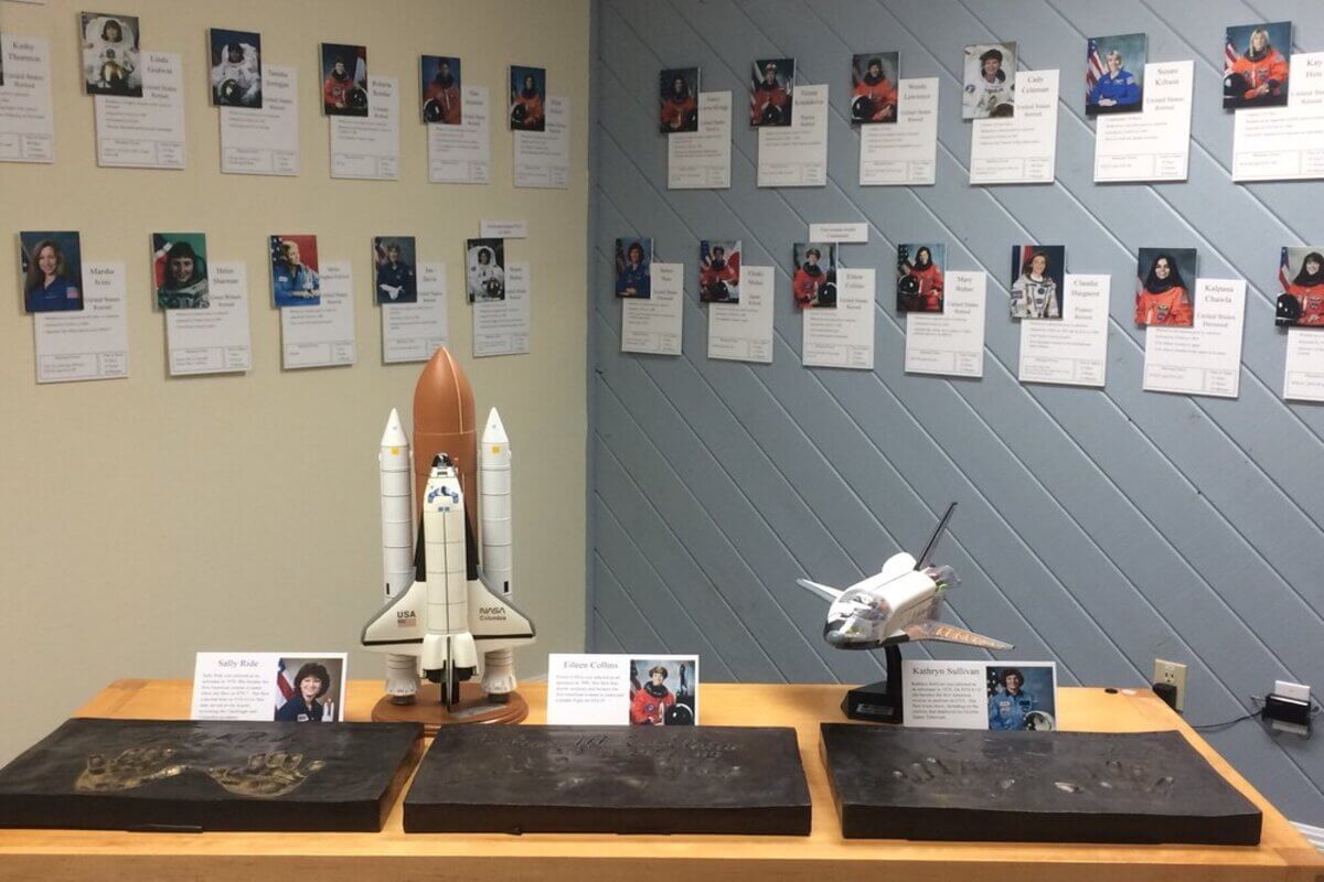 Exhibit with a variety of astronauts pictures and model ships. 