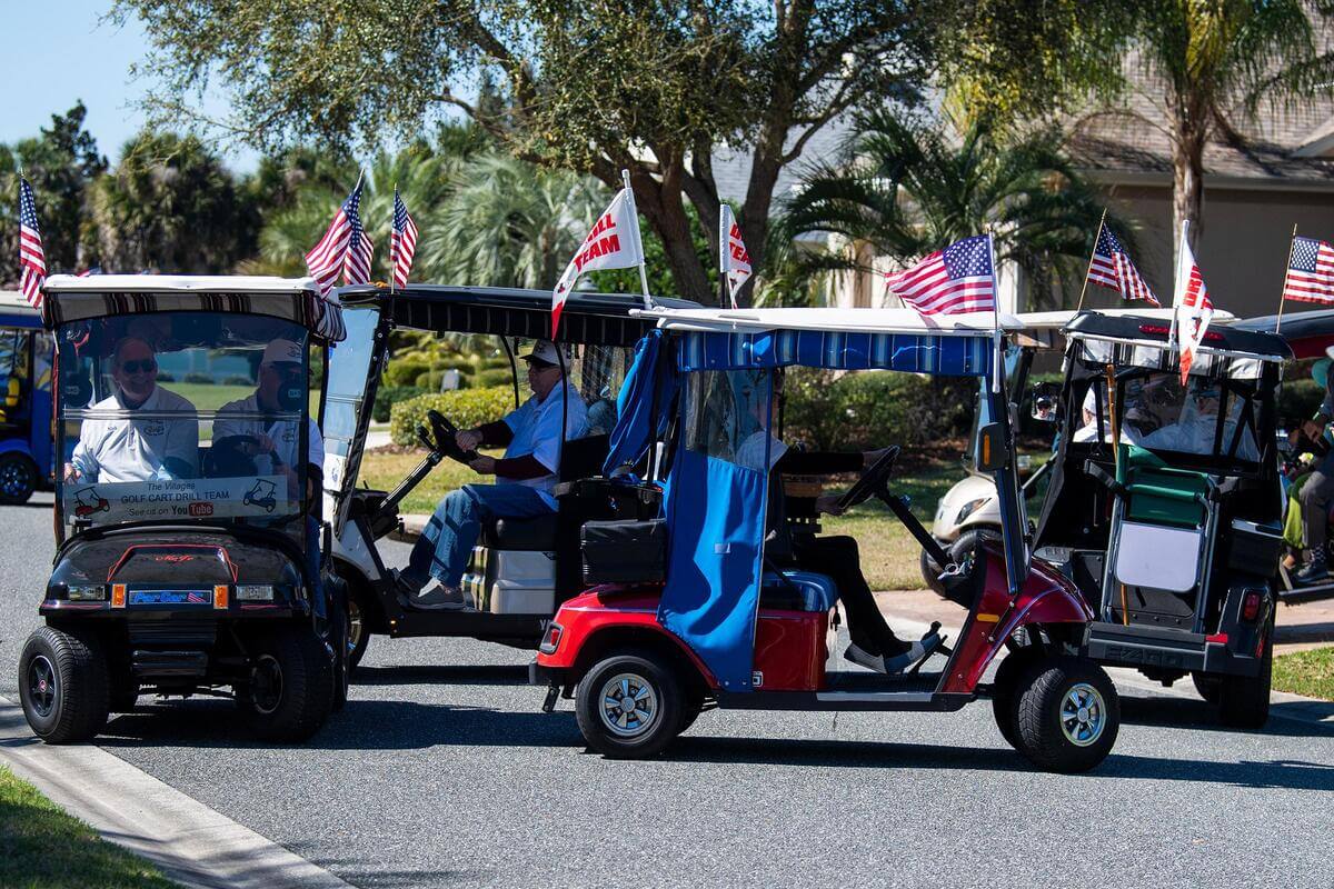 Golf carts with flavs on the top. 