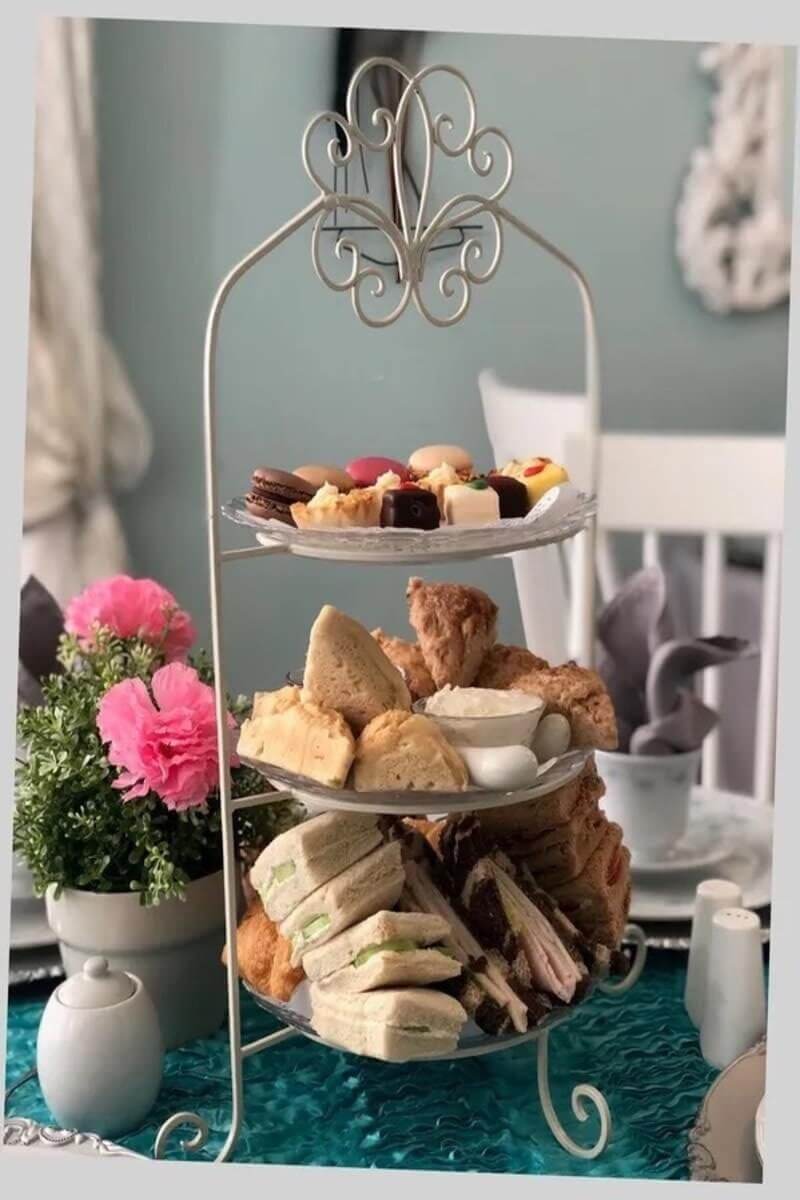 Tea cakes and sandwiches on a tea tray. 