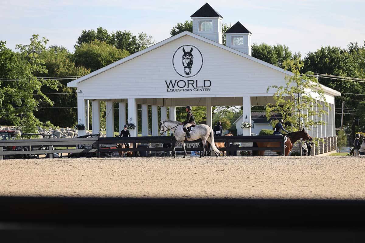 World Equestrian Center exterior with a horse and rider in front of it.
