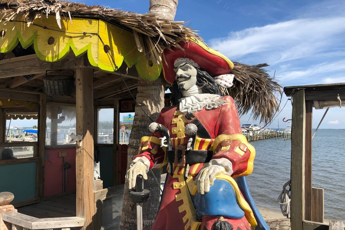 Pirate captain stature in front of the water. 
