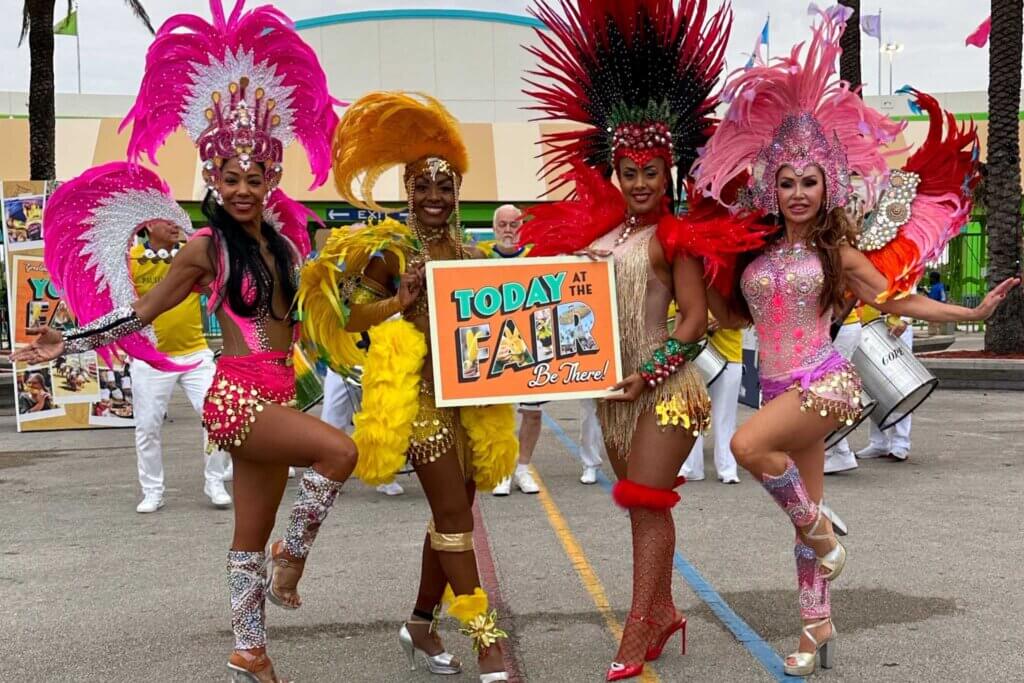 Miami Dade County Fair performers holding a sign. 