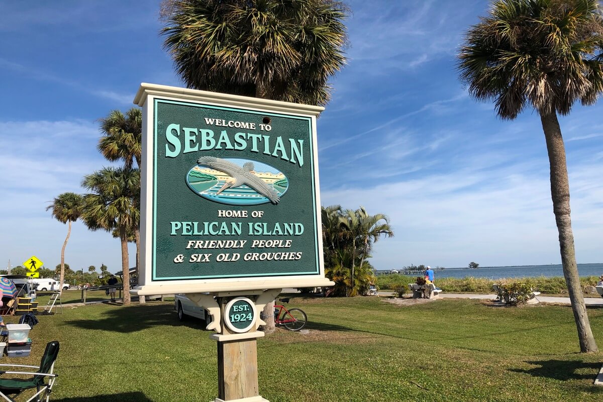 Sign reading Welcome to Sebastian Home of Pelican Island Friendly people and six old grouches. 