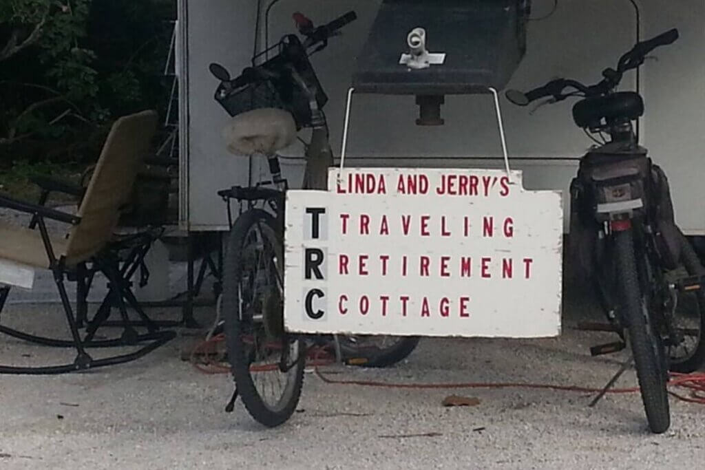 two black bikes with sign and camper