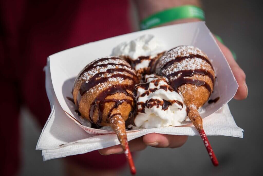 deep fried fair food with whipped cream and chocolate sauce