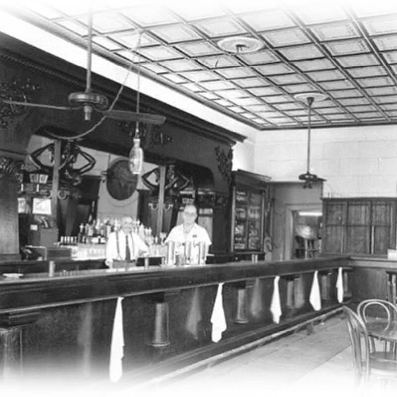old photo of bartender behind counter